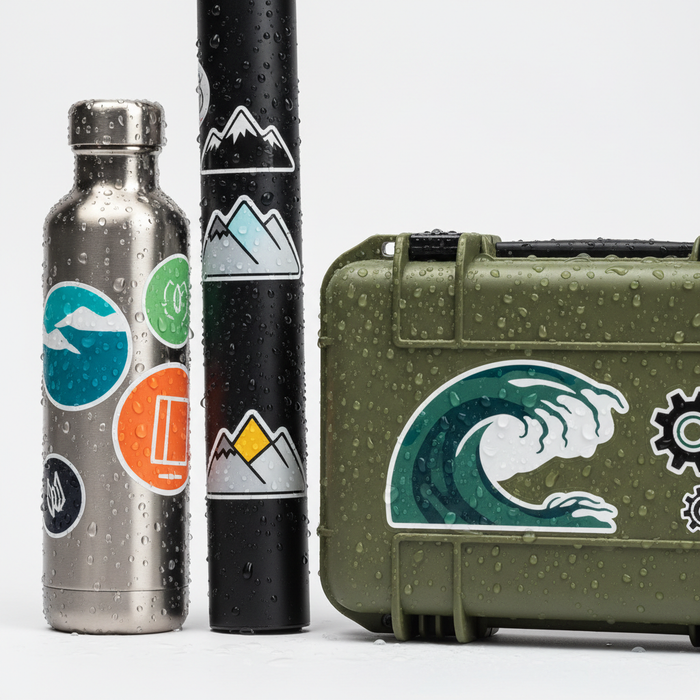 Durable vinyl stickers on a water bottle, a bike frame and a hard shell case with water droplets
