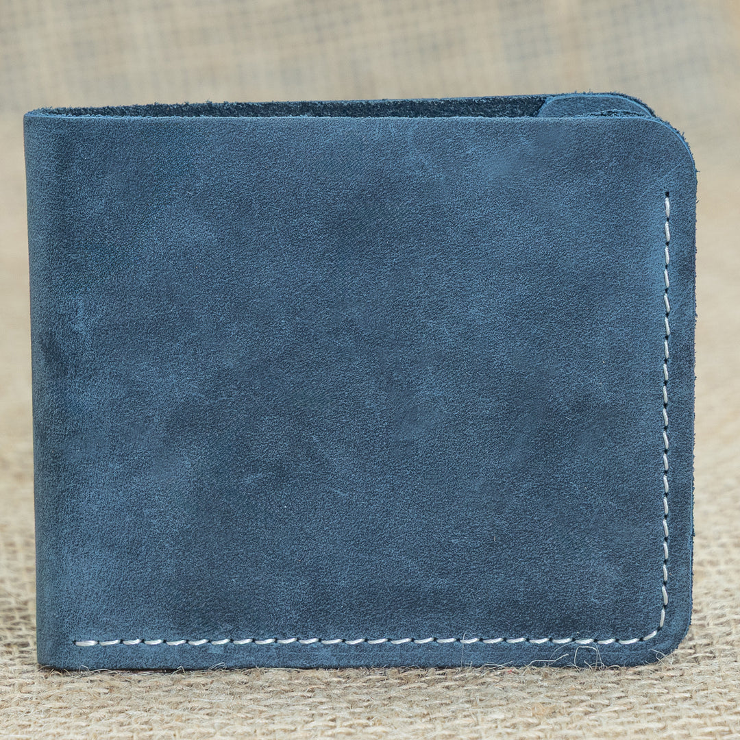 Blue leather wallet on a textured beige background
