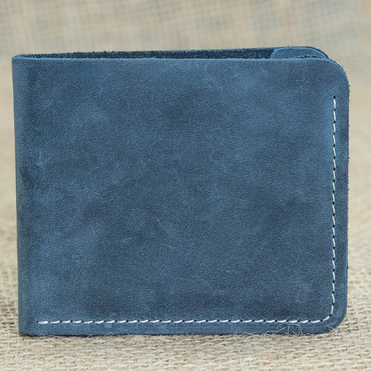 Blue leather wallet on a textured beige background