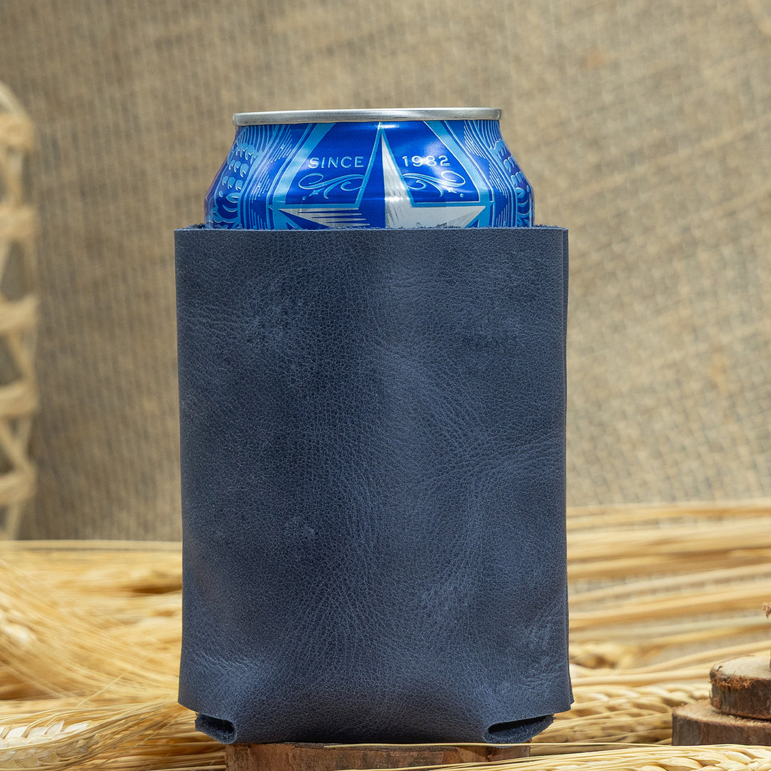 Blue can with a navy leather sleeve on a woven surface